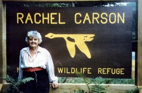 Ann Cottrell Free in front of Rachel Carson Wildlife Refuge sign.